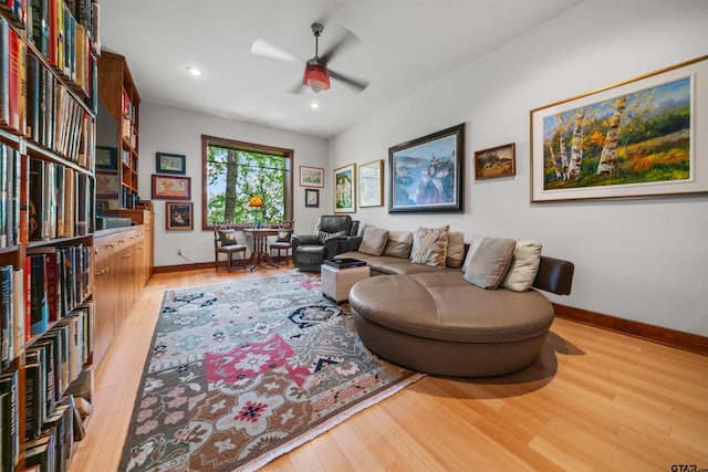 living room featuring ceiling fan and light hardwood / wood-style flooring