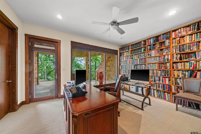 carpeted office featuring ceiling fan