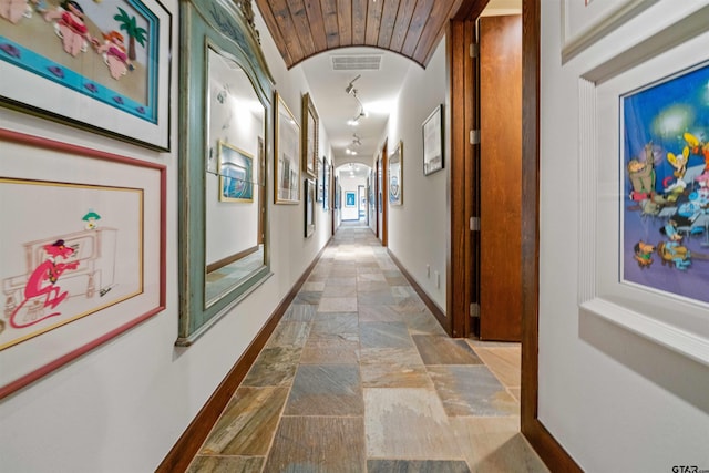 hall featuring wood ceiling and rail lighting