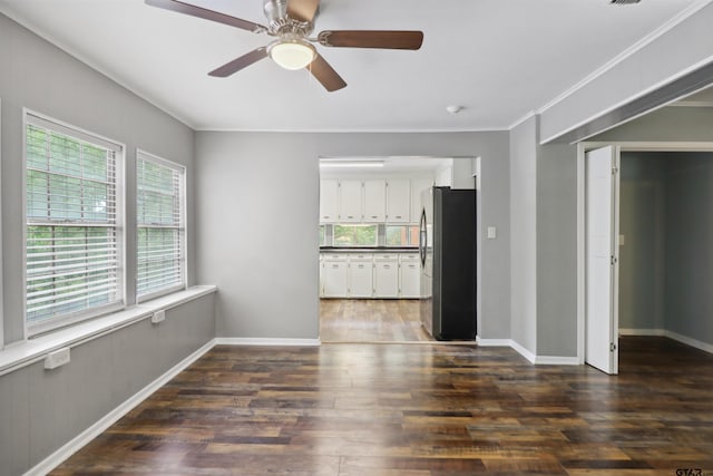 spare room with crown molding, ceiling fan, and dark hardwood / wood-style floors