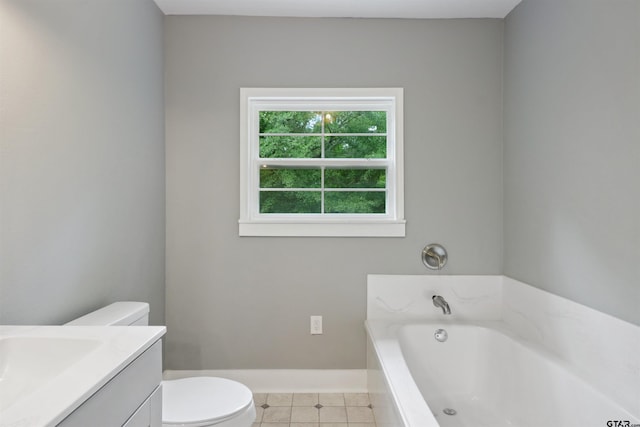 bathroom with tile patterned flooring, vanity, toilet, and a tub