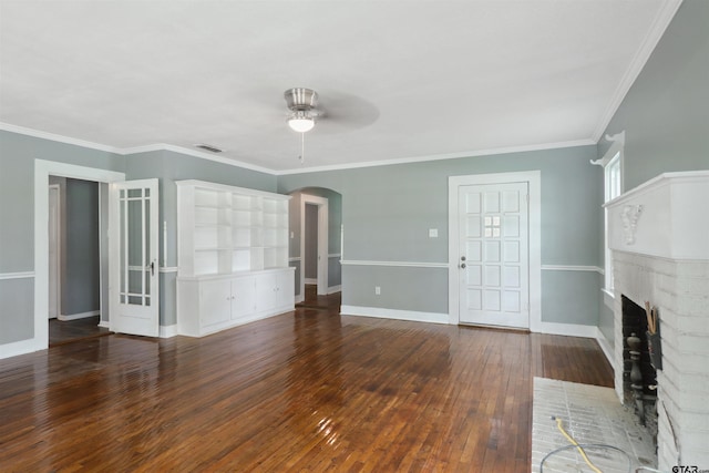 unfurnished living room with ceiling fan, a fireplace, dark wood-type flooring, and ornamental molding