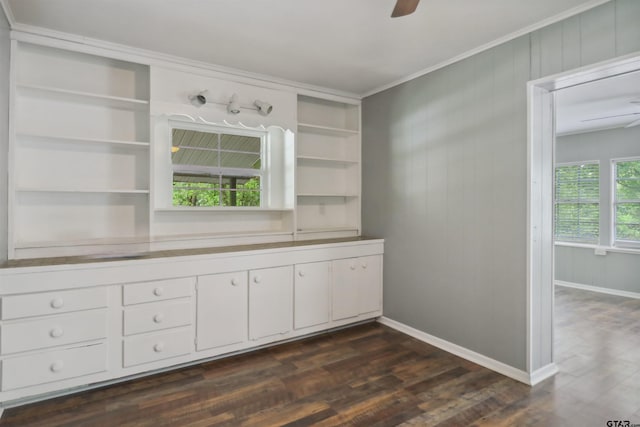 bathroom with ceiling fan, wood walls, wood-type flooring, and ornamental molding