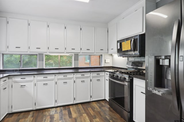 kitchen featuring dark hardwood / wood-style flooring, white cabinetry, and appliances with stainless steel finishes