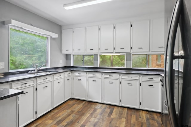 kitchen with white cabinetry, stainless steel refrigerator, dark hardwood / wood-style floors, and sink