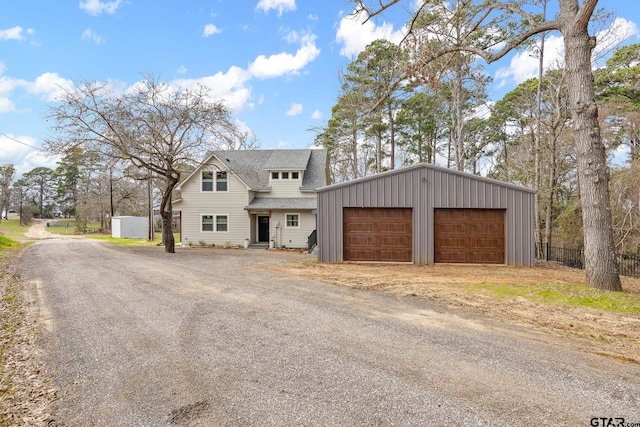 view of front of house featuring a garage and an outdoor structure