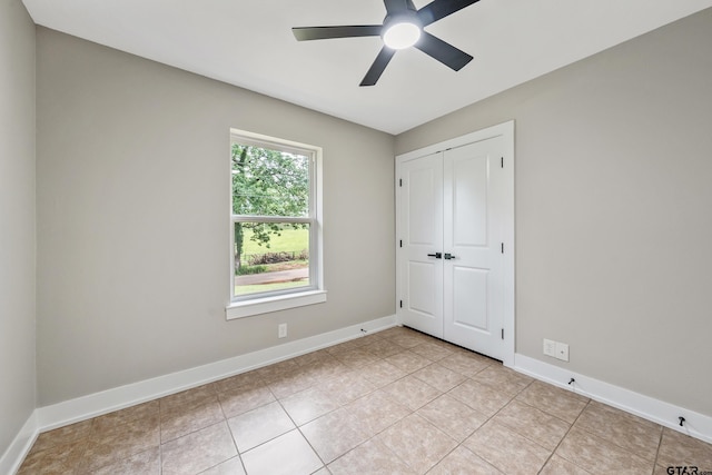10873 Nix Ln, Whitehouse, TX 75791 - unfurnished bedroom with light tile patterned floors, a closet, and a ceiling fan