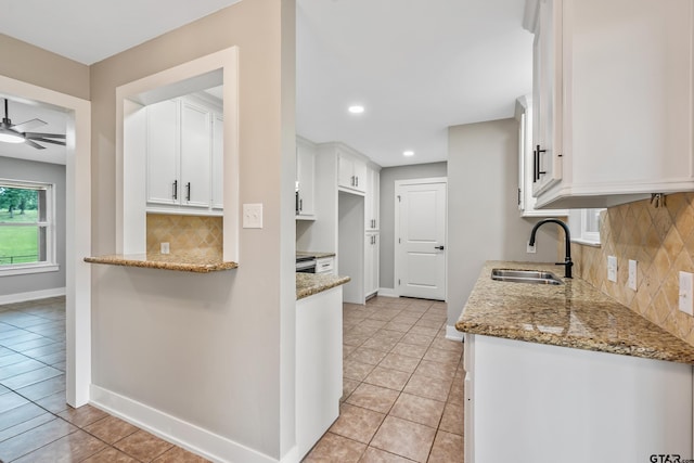 10873 Nix Ln, Whitehouse, TX 75791 - kitchen with white cabinetry, light stone countertops, light tile patterned flooring, backsplash, and recessed lighting