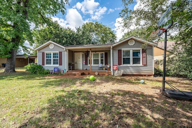 ranch-style house featuring covered porch and a front yard