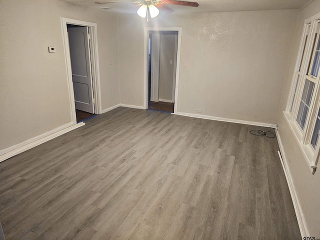 spare room with wood-type flooring and ceiling fan