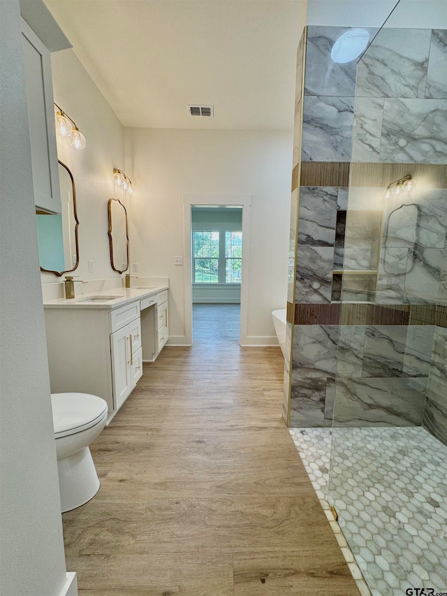 full bathroom with toilet, hardwood / wood-style floors, vanity, and shower with separate bathtub