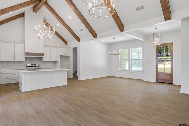 kitchen with decorative backsplash, a center island, white cabinets, and light wood-type flooring