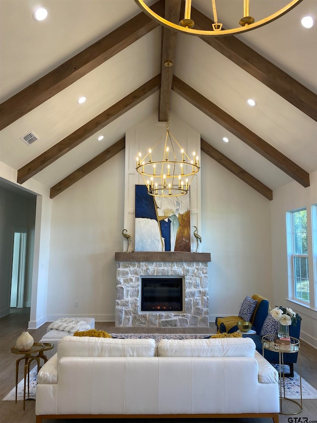 living room with hardwood / wood-style floors, vaulted ceiling with beams, a stone fireplace, and a chandelier