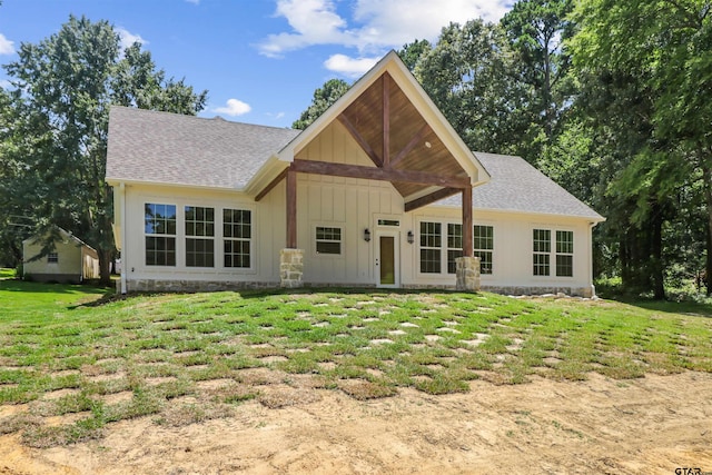 rear view of property with a yard