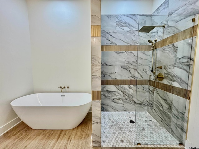 bathroom with independent shower and bath and hardwood / wood-style flooring