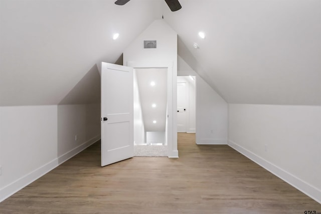 additional living space with ceiling fan, light hardwood / wood-style flooring, and vaulted ceiling