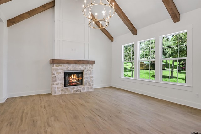 unfurnished living room with beam ceiling, hardwood / wood-style flooring, high vaulted ceiling, a fireplace, and a chandelier