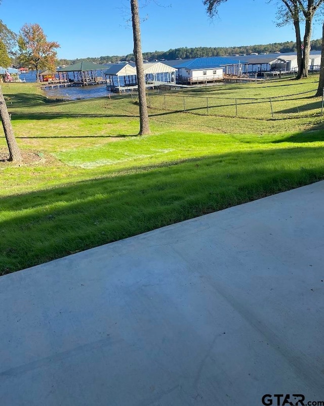 view of property's community with a yard and a patio