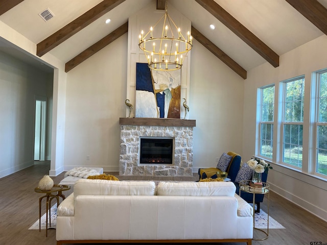 living room with beam ceiling, dark hardwood / wood-style flooring, an inviting chandelier, and a stone fireplace