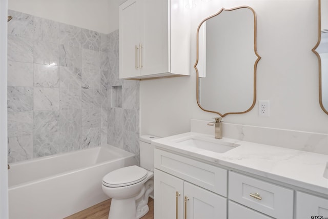 full bathroom featuring vanity, toilet, wood-type flooring, and tiled shower / bath