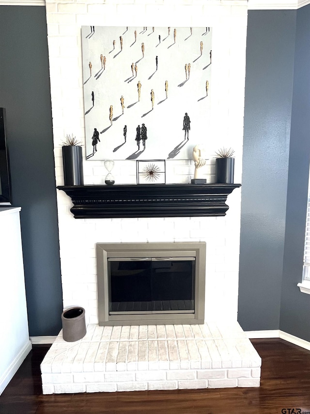 9112 Deerfield Dr, Tyler, TX 75703 - detailed view of baseboards, wood finished floors, and a brick fireplace
