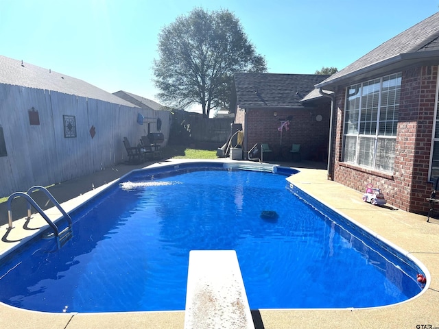 9112 Deerfield Dr, Tyler, TX 75703 - view of swimming pool featuring a fenced backyard, a patio, and a diving board