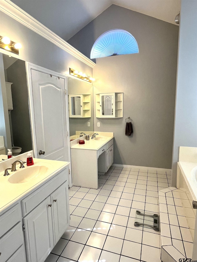 9112 Deerfield Dr, Tyler, TX 75703 - bathroom with lofted ceiling, tile patterned floors, two vanities, and a garden tub