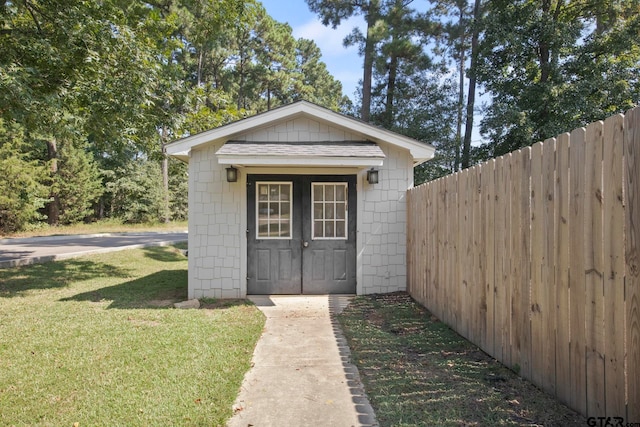 view of outbuilding featuring a lawn