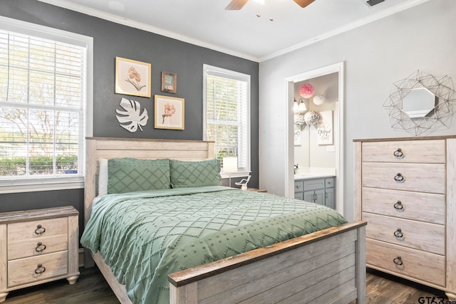 bedroom with crown molding, dark hardwood / wood-style floors, ceiling fan, and connected bathroom