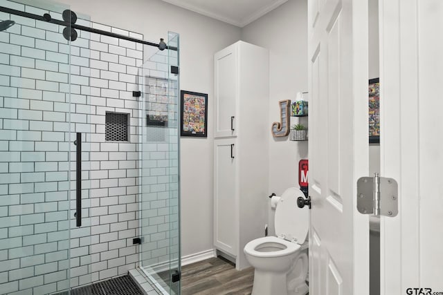 bathroom with walk in shower, toilet, hardwood / wood-style floors, and crown molding