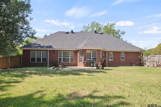 back of property featuring a yard and a patio area