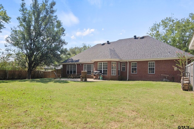 rear view of property with a patio area and a yard