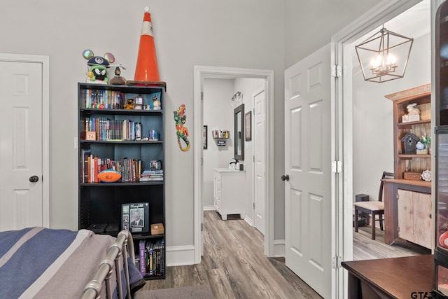 bedroom featuring wood-type flooring and a chandelier