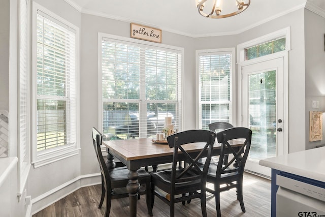 dining area with a healthy amount of sunlight, a notable chandelier, light wood-type flooring, and ornamental molding