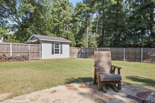 view of yard featuring an outbuilding and a patio