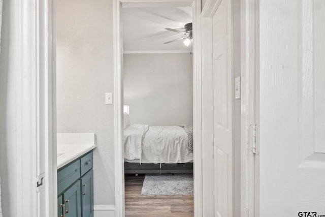 bathroom with vanity, hardwood / wood-style floors, ceiling fan, and crown molding