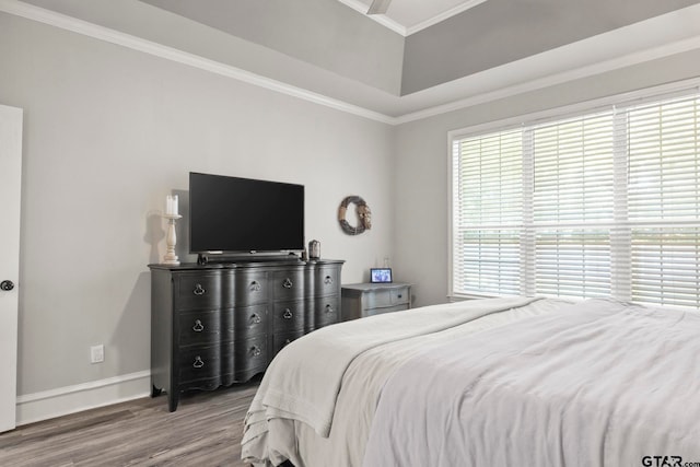 bedroom with light wood-type flooring and crown molding