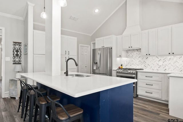 kitchen with white cabinetry, appliances with stainless steel finishes, sink, and decorative light fixtures