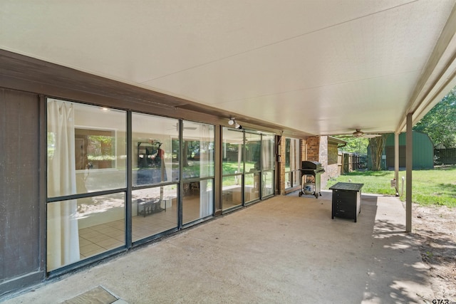 view of patio / terrace with a storage shed, grilling area, a ceiling fan, and an outdoor structure