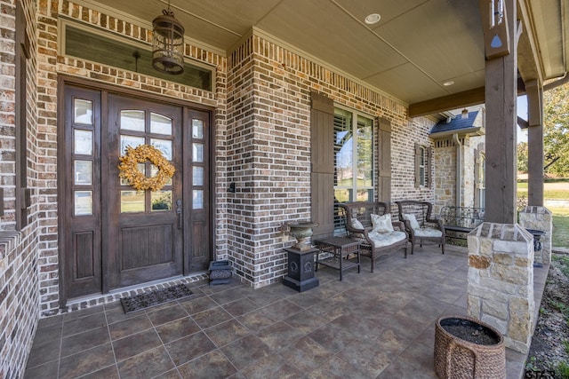 view of exterior entry with a porch