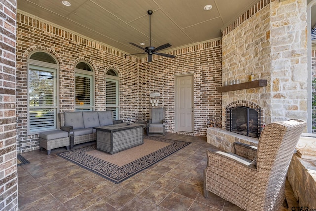 view of patio / terrace featuring an outdoor living space with a fireplace and ceiling fan