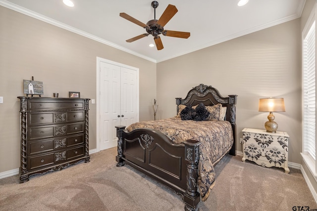 carpeted bedroom with ceiling fan, crown molding, and a closet