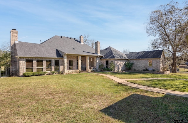 rear view of property featuring a yard