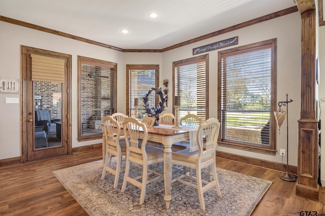 dining area featuring hardwood / wood-style flooring and ornamental molding