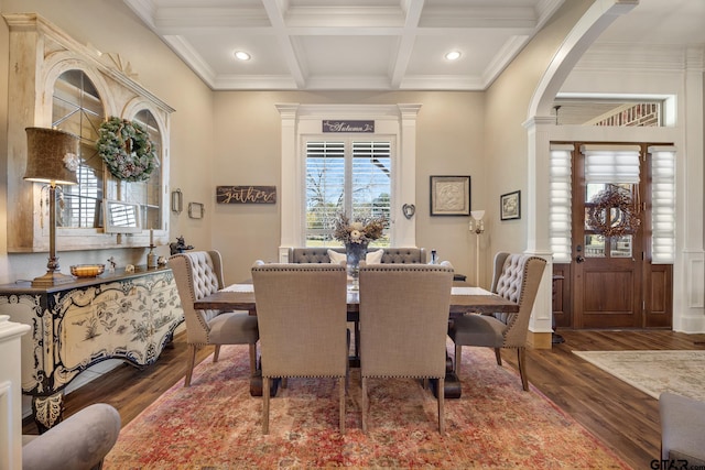 dining room with crown molding, beamed ceiling, coffered ceiling, and hardwood / wood-style flooring