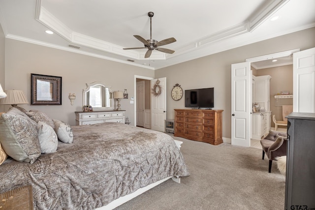 carpeted bedroom with a tray ceiling, ceiling fan, and ornamental molding