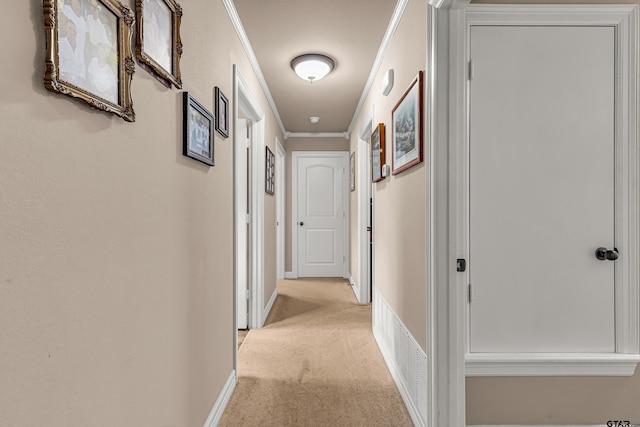 hall featuring light colored carpet and crown molding