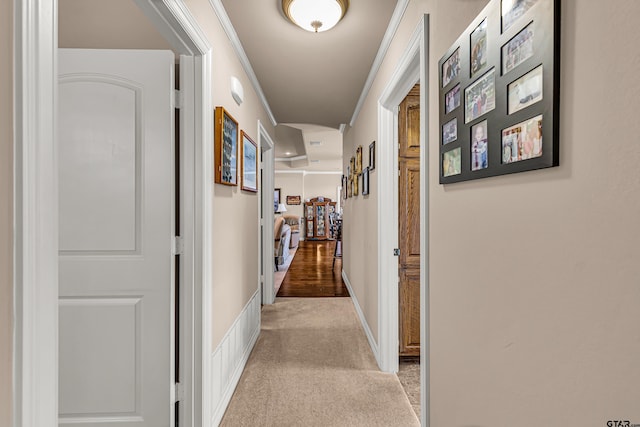 hall with light carpet and crown molding