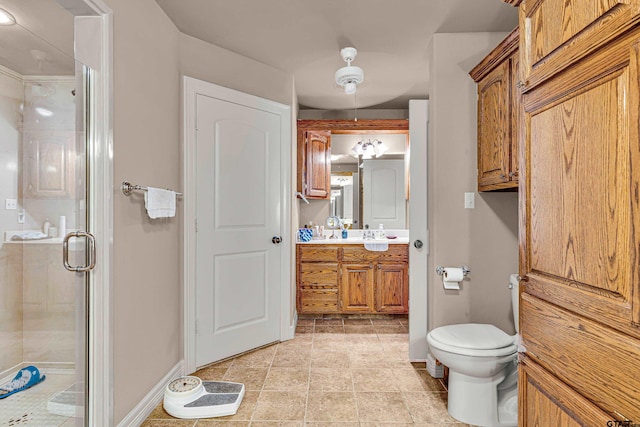 bathroom with vanity, tile patterned floors, toilet, and a shower with door