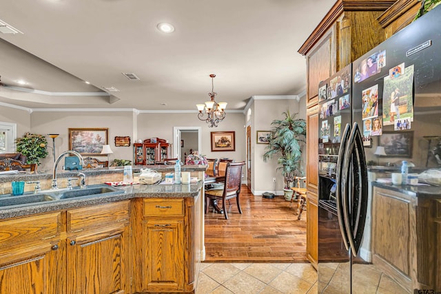 kitchen with crown molding, fridge with ice dispenser, light wood-type flooring, an inviting chandelier, and sink